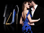 Couple embracing with a high-heeled shoe and packaging in the foreground on a dark background